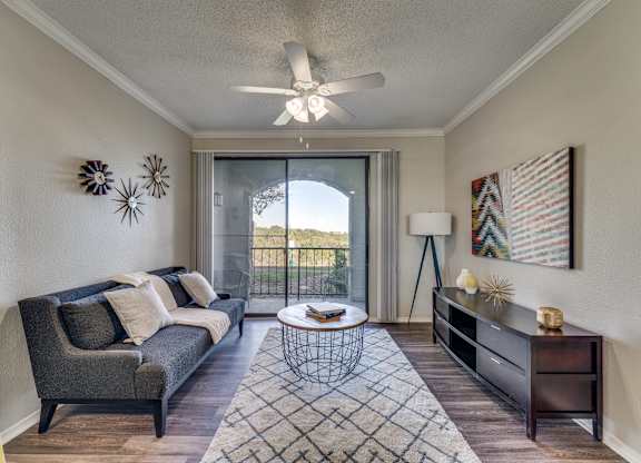 a living room with a couch and a ceiling fan