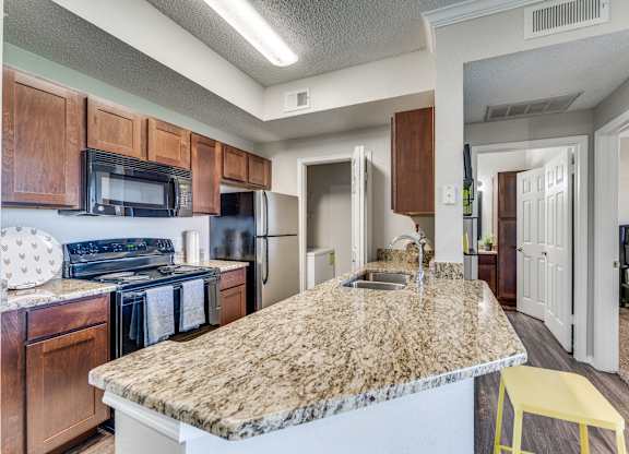an expansive kitchen with granite countertops and a large island