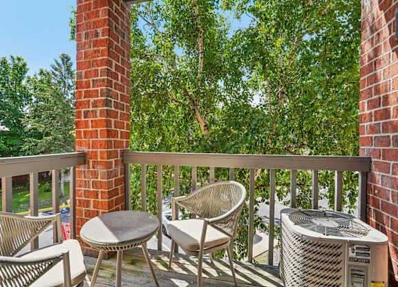 A patio with a table and chairs and a fan.