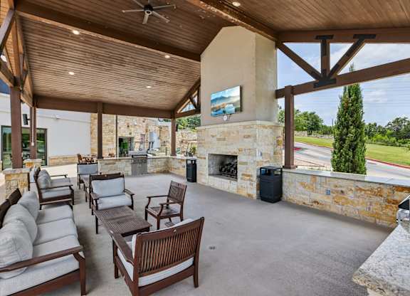 A patio with a fireplace and a painting on the wall.