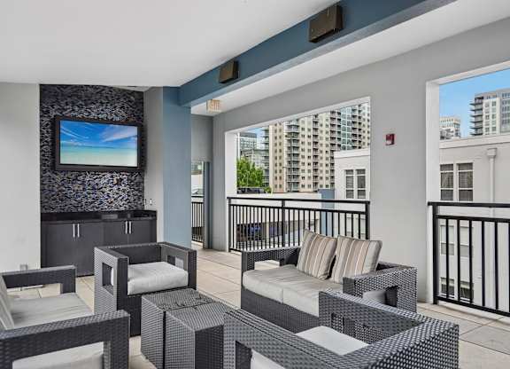 A balcony with a black railing and a white couch.