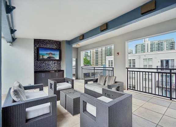 A balcony with a black railing and a television mounted on the wall.