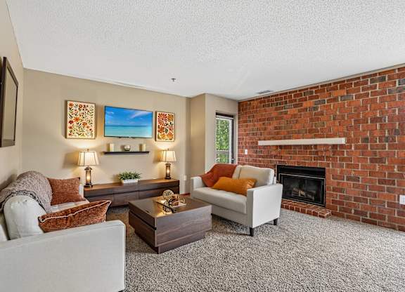 A living room with a fireplace and a couch.