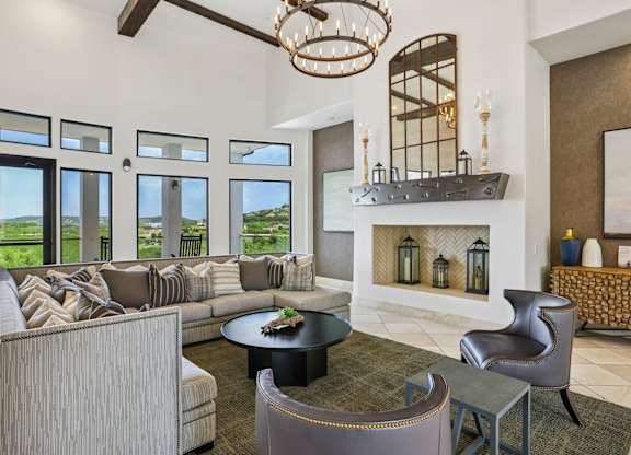 A living room with a fireplace and a large window.