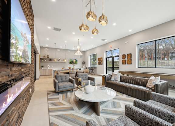 a living room with couches and chairs and a fireplace