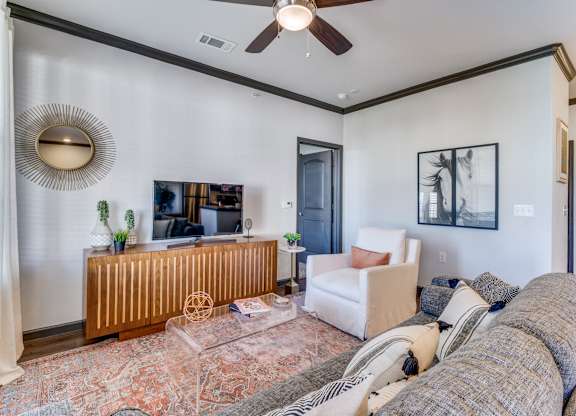 a living room with a couch and a ceiling fan