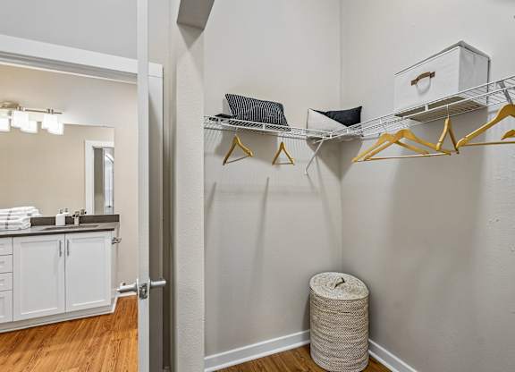 A white bathroom with a white vanity and a white towel on the counter.