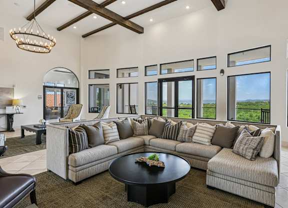 A large, well-lit living room with a long couch and a coffee table.