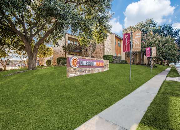 A Chisholm sign is displayed in front of a building.