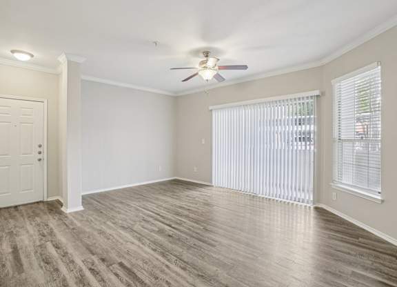 A room with a ceiling fan and a door.