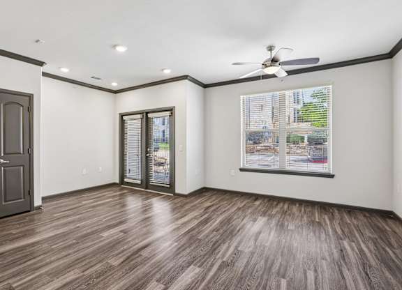A room with a wood floor and a ceiling fan.