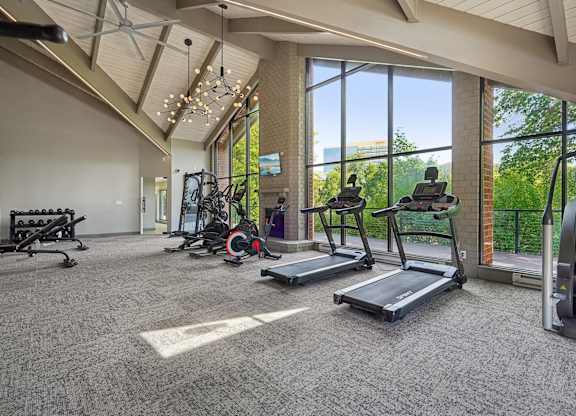 A spacious gym with treadmills, elliptical machines, and other exercise equipment.