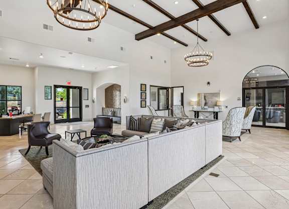 A spacious living room with a reception desk and chairs.