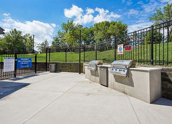 A black fence surrounds a concrete structure with a sign that reads "BOLTED".