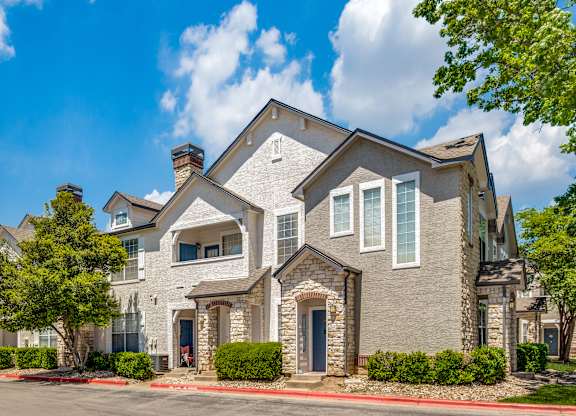the view of a house with a street in front of it