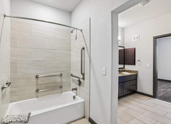 A white bathroom with a walk-in shower and a white bathtub.