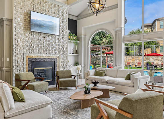 A living room with a fireplace and a painting above it.