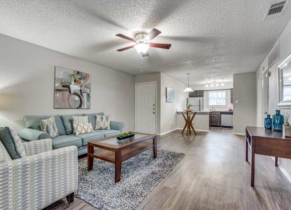 A living room with a couch, chair, and coffee table.