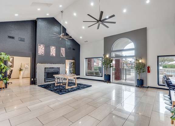 A spacious living room with a fireplace and a dining table.