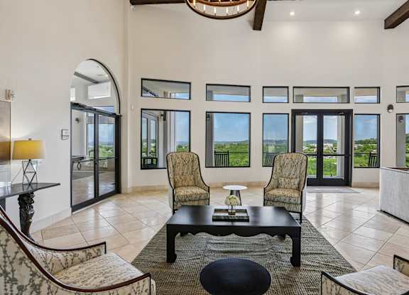 A living room with a black coffee table and chairs.
