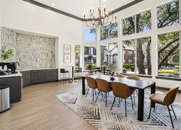 A modern dining room with a large table and chairs.