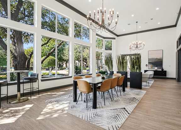 A modern dining room with a large table and chairs.