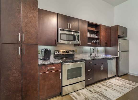 12 South Apartments - Nashville TN - kitchen with dark wood cabinets and stainless steel appliances