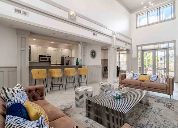 A living room with a brown couch and a coffee table.