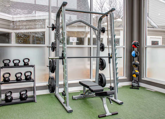 Free weights in fitness center, smith machine