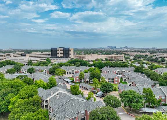 an aerial view of a neighborhood with houses and trees