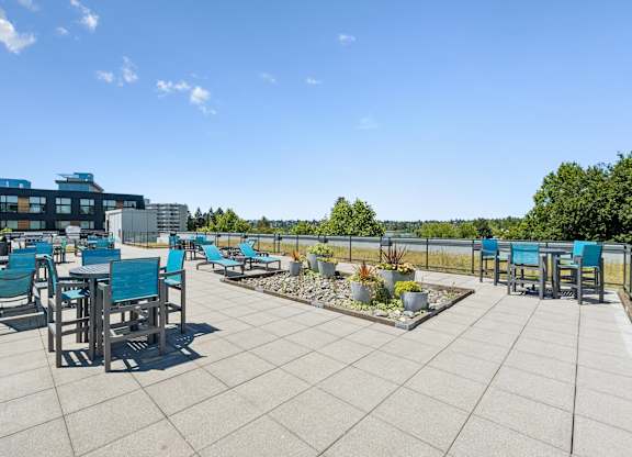 A sunny day at the outdoor seating area of a modern building.