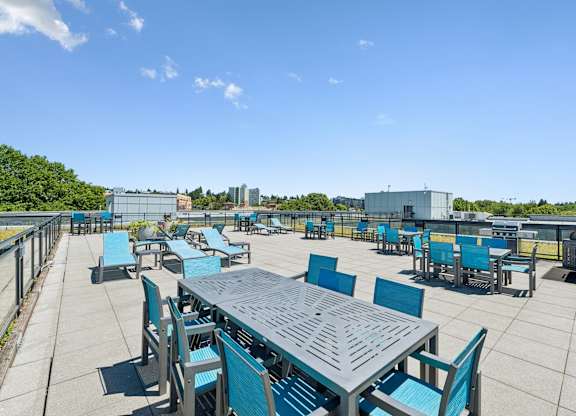 A large table surrounded by chairs on a patio.