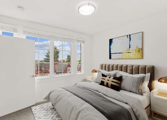 a bedroom with a bed and two windows