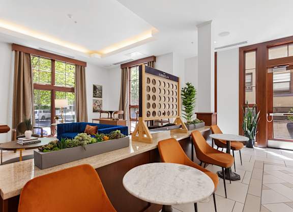 a living room with tables and chairs and a blue couch