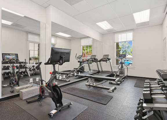 the gym with treadmills and other exercise equipment at the belgard apartments