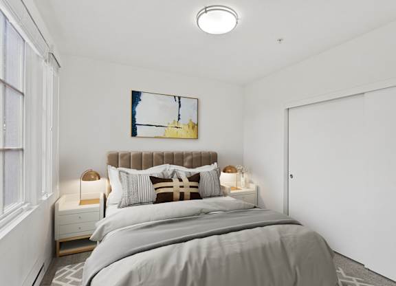 a bedroom with a bed and a large window