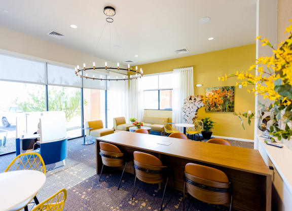 a dining room with a long wooden table and chairs