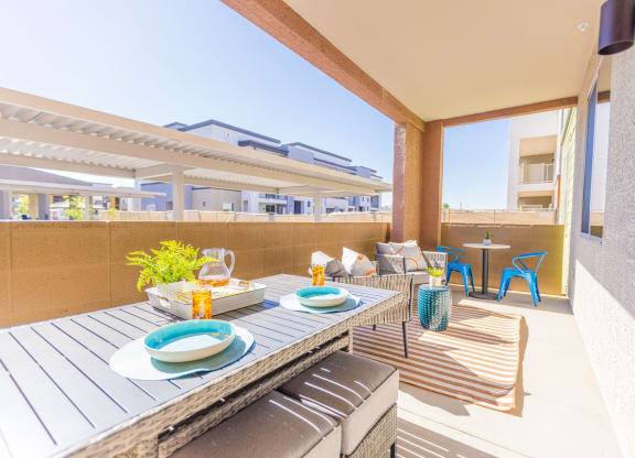 a dining area with a table and chairs on a balcony
