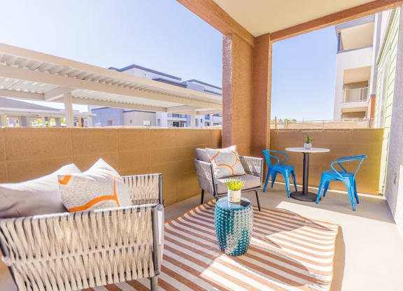 a patio with a table and chairs and a couch