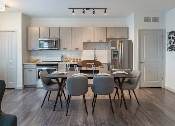 Riverview, FL Apartments – Sole at Brandon - luxury kitchen with stainless steel appliances, granite countertops, hardwood flooring.