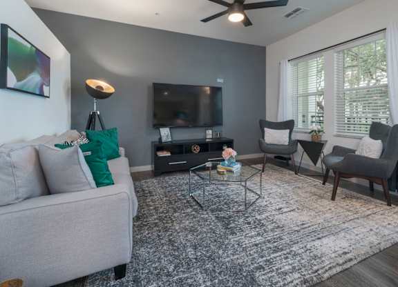 Riverview, FL Apartments – Sole at Brandon - living room with hardwood floors, ceiling fan, and large windows