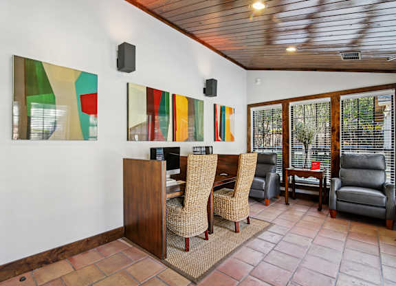 A room with a wooden bar and chairs.