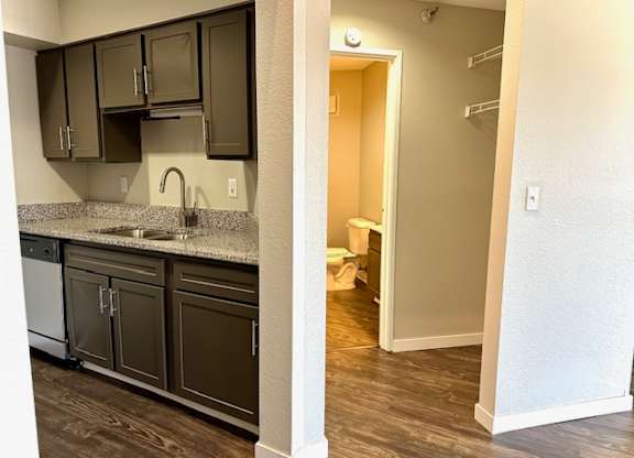 a kitchen with black cabinets and a sink