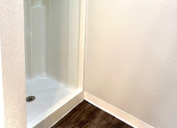 a bathroom with a shower and a towel rack