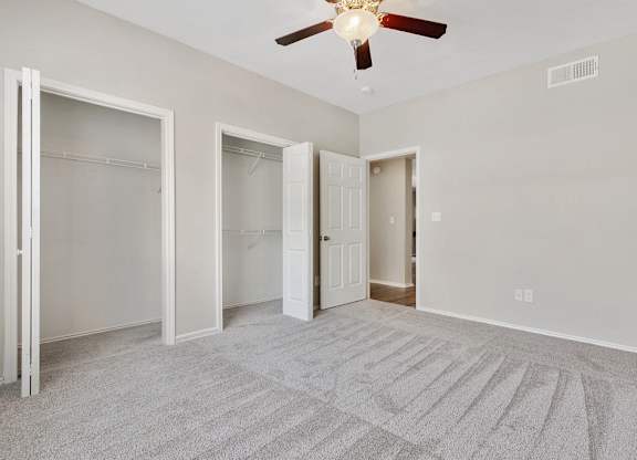 Luxury One Bedroom Apartments in Plano, TX - Carrington Park Apartments Bedroom With Ceiling Fan, Plush Carpeting and Large Closets