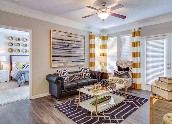 Pet-Friendly Apartments in Alpharetta, GA – The Ascent at Windward – living room with lots of space, hardwood floors, ceiling fans and large windows