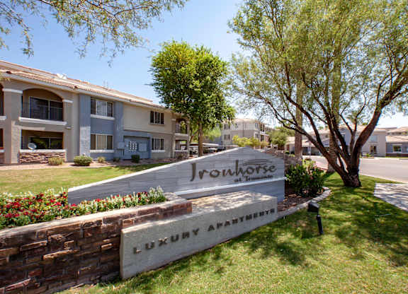 Apartments in North Phoenix AZ - Ironhorse at Tramonto - Building Exterior with Entry Sign, Landscaping and Street View