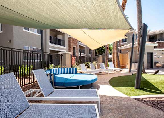 North Phoenix Luxury Apartments -Ironhorse at Tramonto Outdoor Lounge with Chairs and Large Couch Near the Swimming Pool