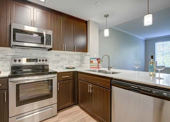 Apartments for Rent in Walnut Creek, CA- Ivy Hill- Kitchen with Stainless-Steel Appliances, Wood-Style Cabinetry, and Quartz Countertops
