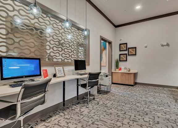 a conference room with a desktop computer on a desk